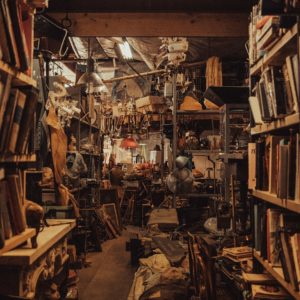 a room filled with lots of books and furniture