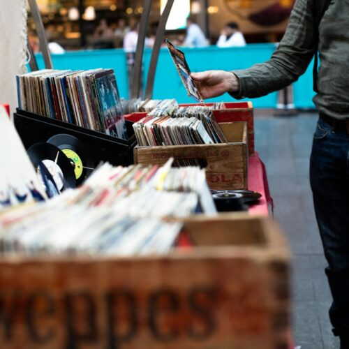 men standing in front of vinyl record sale